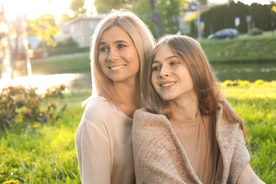 Happy mother with her daughter spending time together in park on sunny day