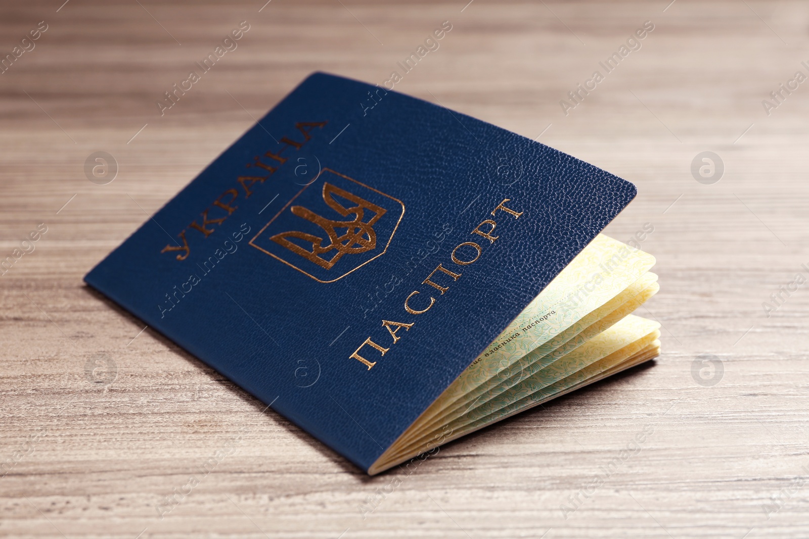 Photo of Ukrainian internal passport on wooden background, closeup
