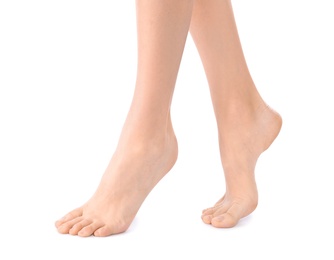 Photo of Young woman with perfect smooth skin on white background, closeup of feet. Beauty and body care