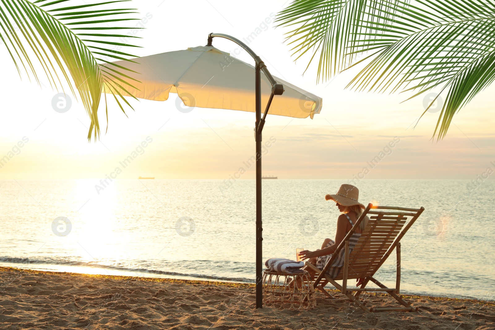 Image of Woman enjoying her summer vacation on sandy beach