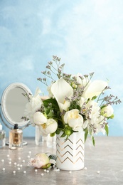 Vase with bouquet of beautiful flowers on table