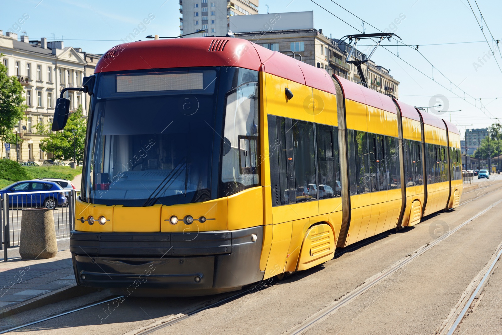 Photo of Modern yellow tram on railways in city
