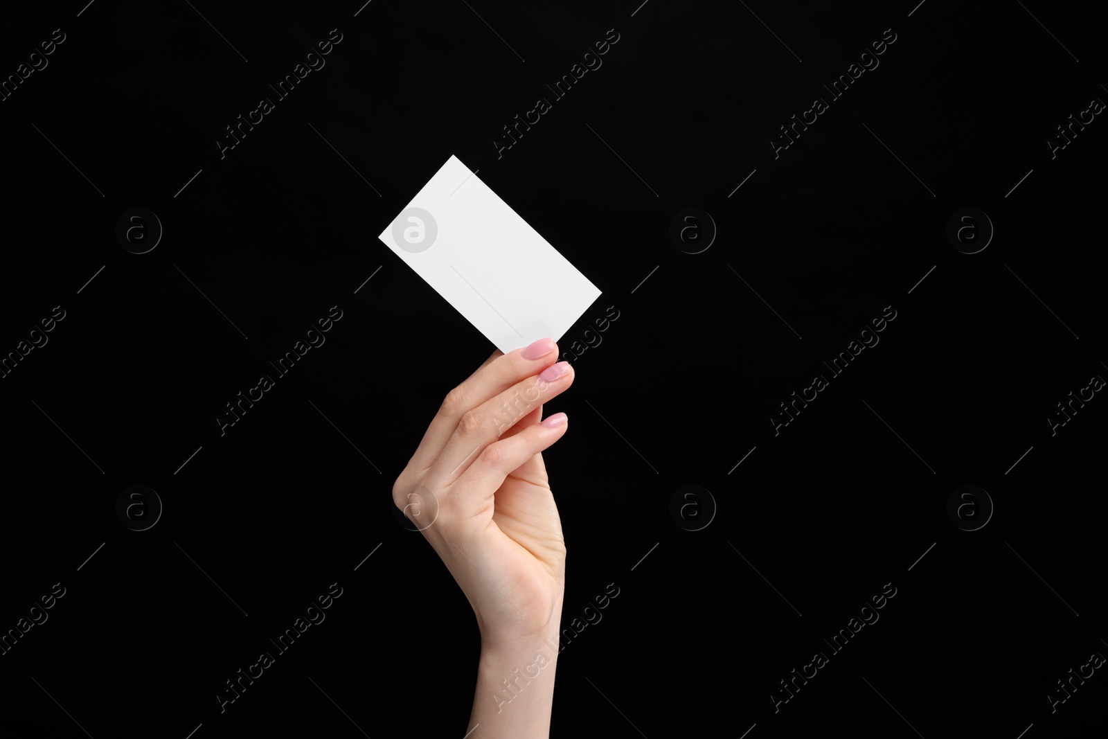 Photo of Woman holding blank business card on black background, closeup. Space for text