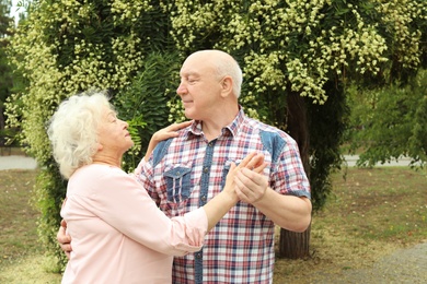Photo of Cute elderly couple in love dancing outdoors