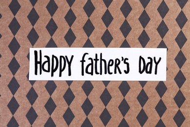 Photo of Phrase "Happy father's day" on color background