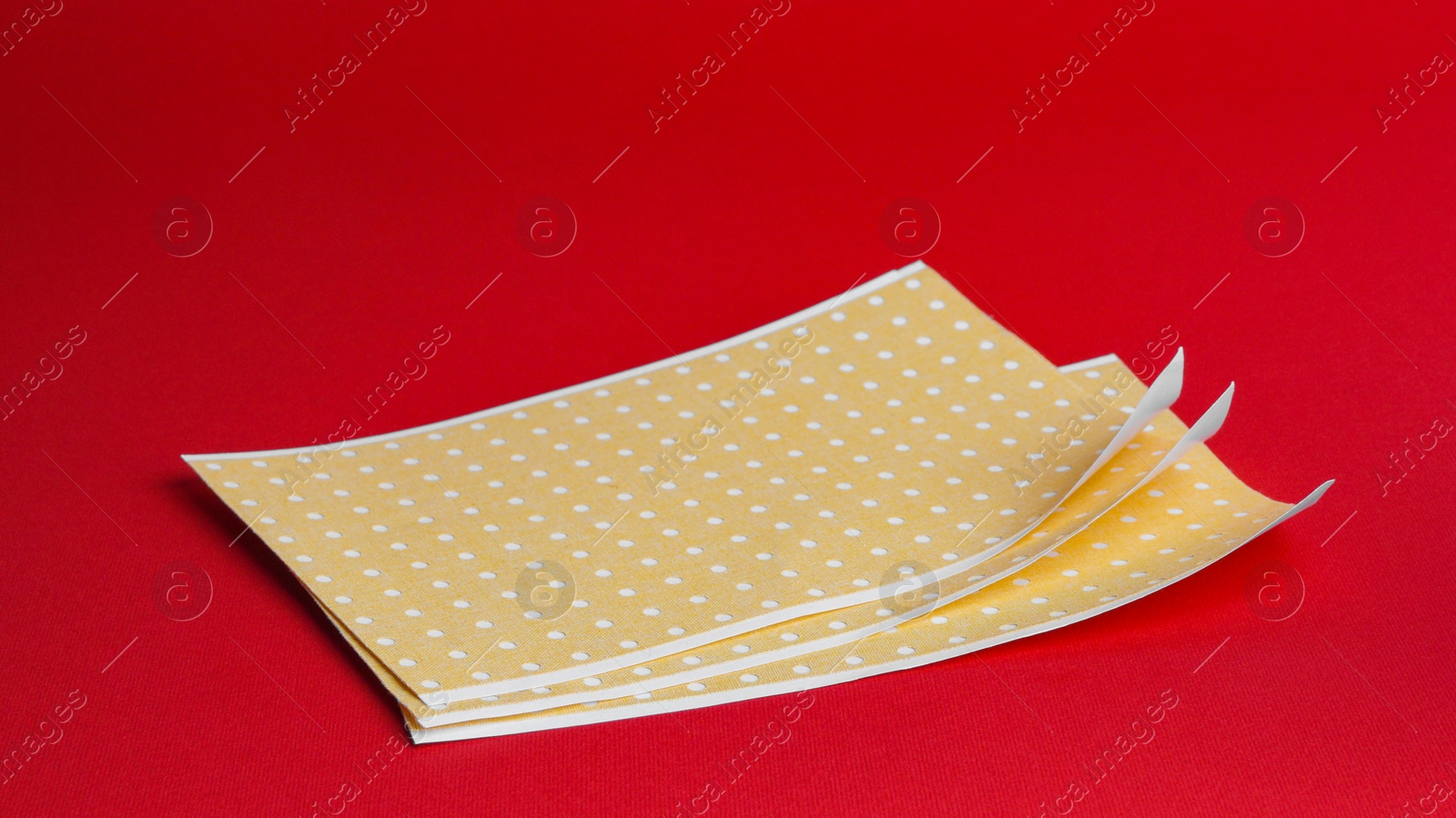 Photo of Pepper plasters on red background. Alternative medicine