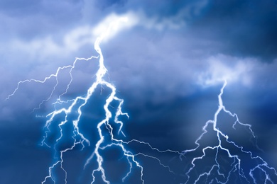 Lightnings in dark cloudy sky during thunderstorm