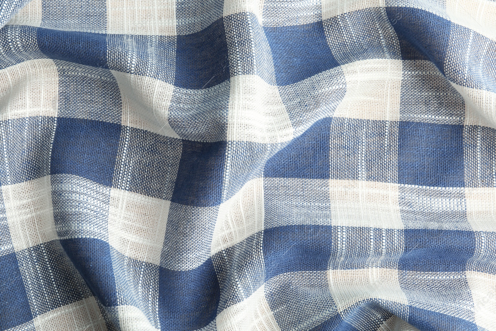 Photo of Texture of blue checkered fabric as background, closeup