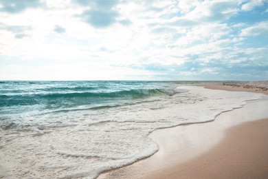 Photo of Sea waves rolling onto sandy tropical beach