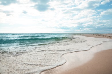 Sea waves rolling onto sandy tropical beach