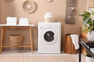 Stylish laundry room with modern washing machine. Interior design