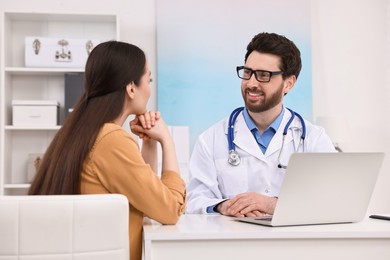 Photo of Doctor consulting patient during appointment in clinic