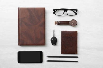 Flat lay composition with male accessories and car key on light background. Space for text