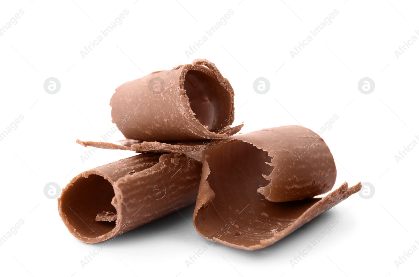 Photo of Delicious milk chocolate curls on white background