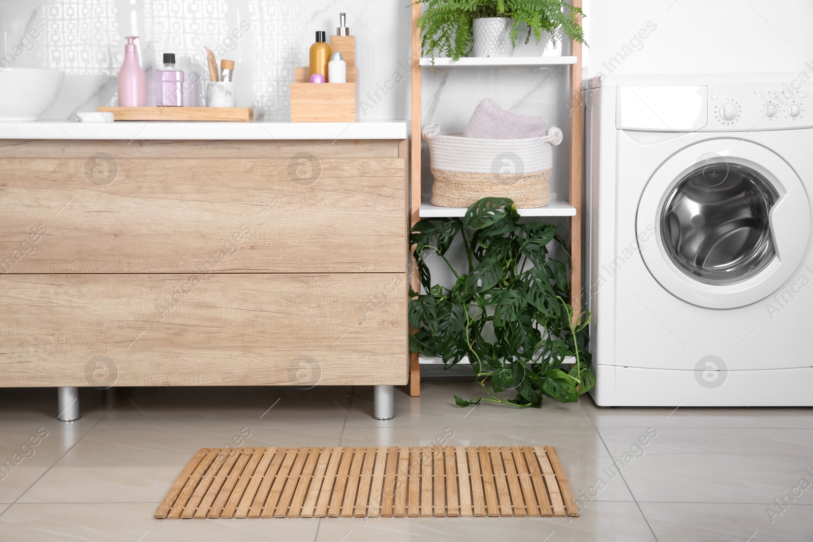 Photo of Wooden mat on floor near counter in bathroom