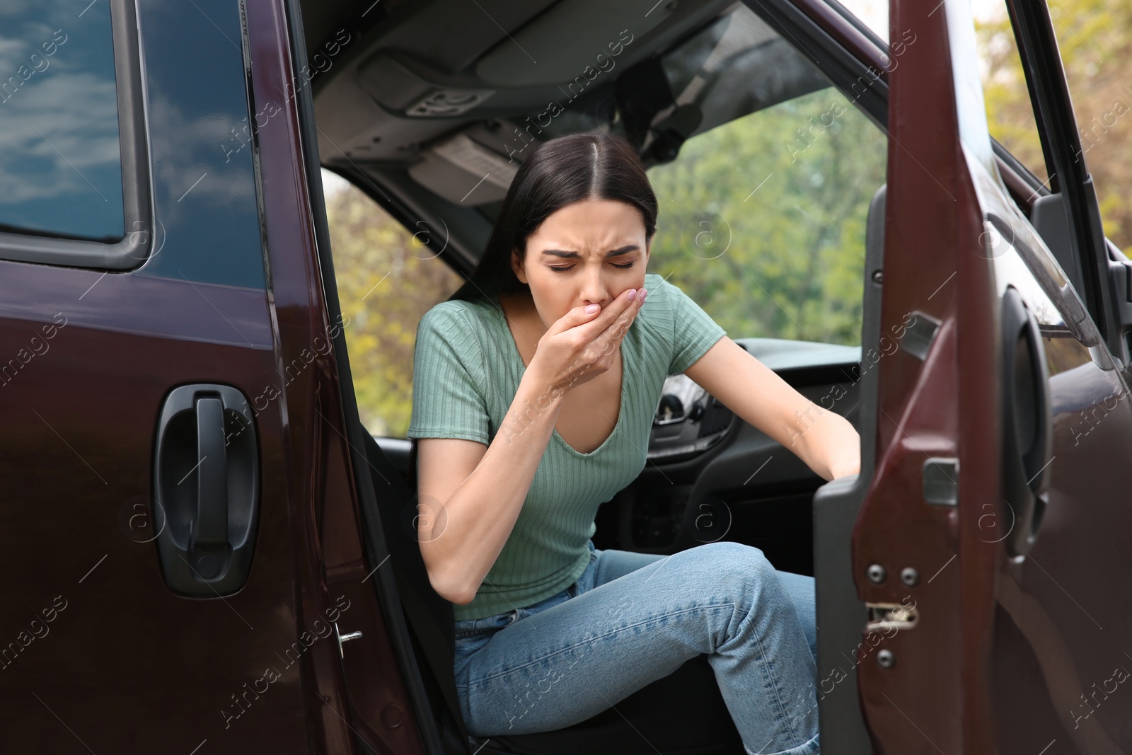 Photo of Young woman suffering from nausea in car