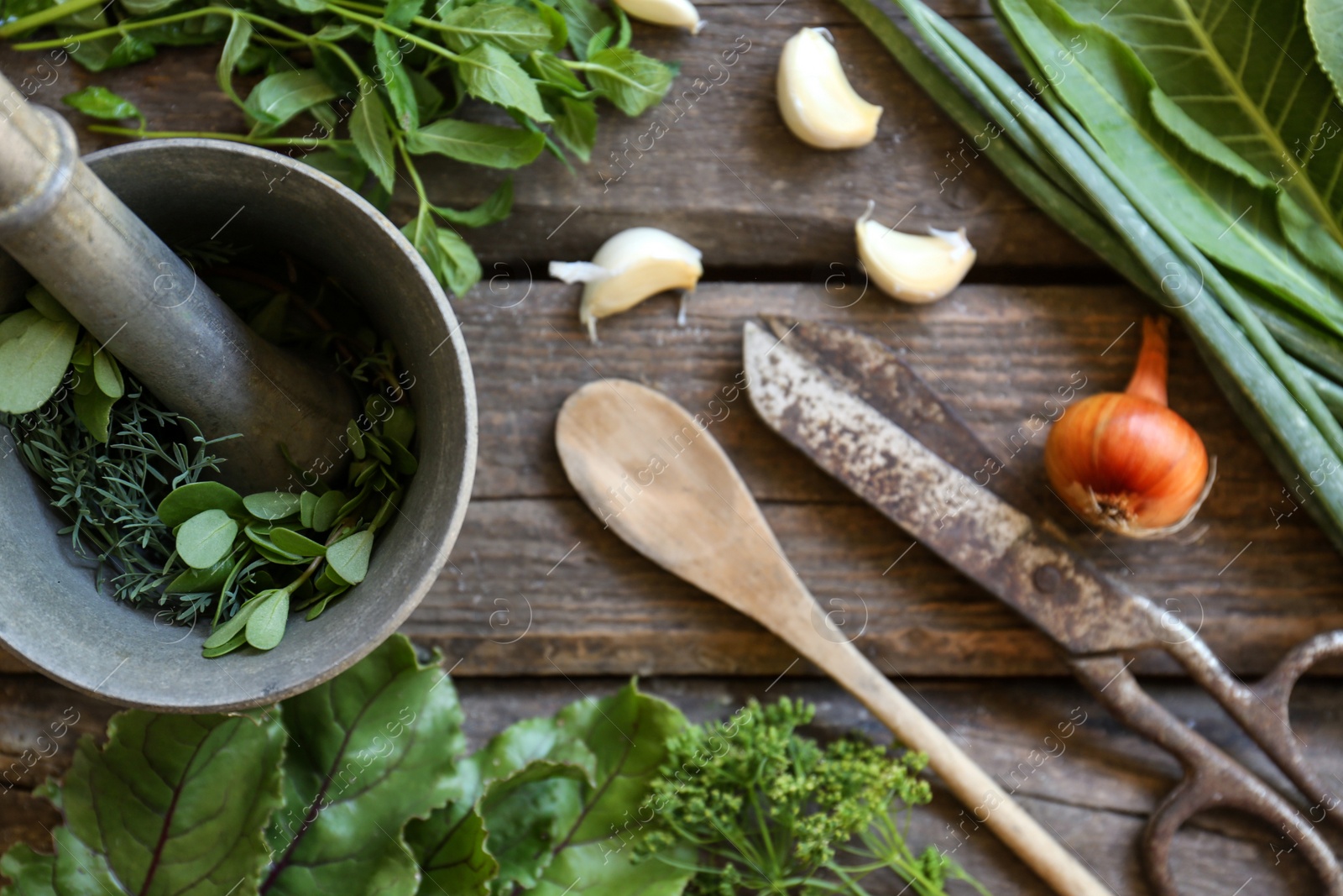 Photo of Flat lay composition with different herbs, rusty scissors and spoon on wooden table