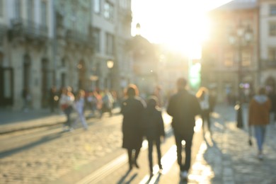 Photo of Blurred view of people walking on city street