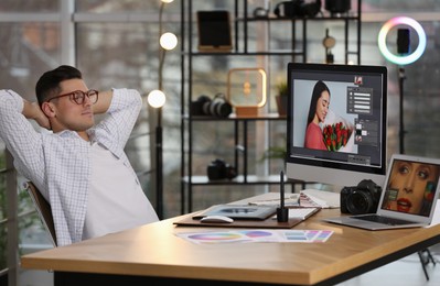 Photo of Professional retoucher at workplace with computer in office