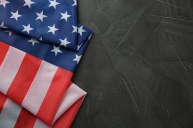 Photo of Flag of USA on black table, top view. Space for text