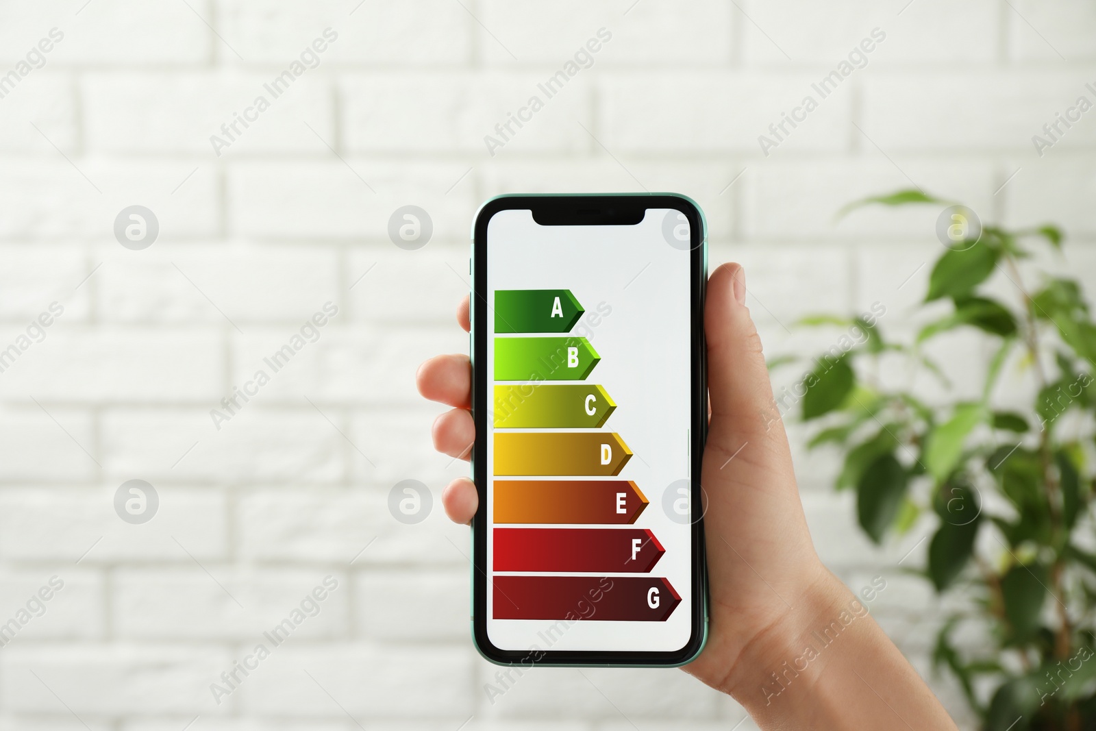 Image of Energy efficiency. Woman using smartphone with colorful rating on display indoors, closeup