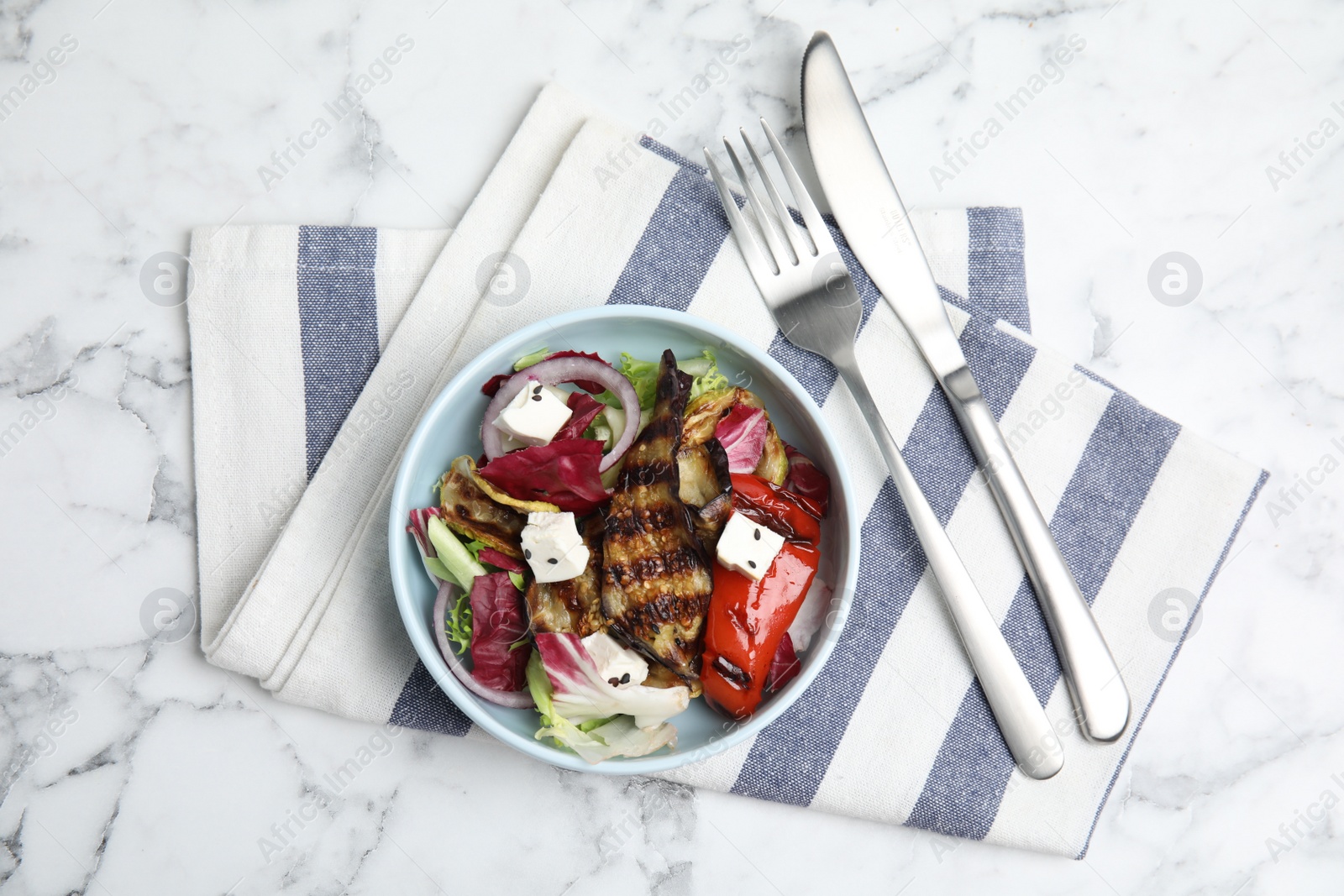 Photo of Delicious salad with roasted eggplant, feta cheese and chia seeds served on white marble table, flat lay