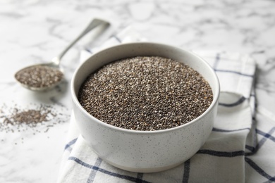 Photo of Bowl with chia seeds on marble background