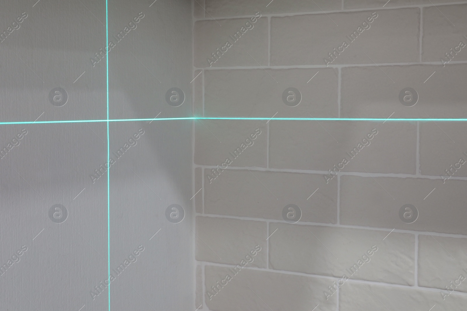 Photo of Cross lines of laser level on white walls