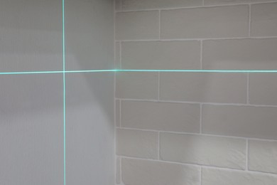 Photo of Cross lines of laser level on white walls