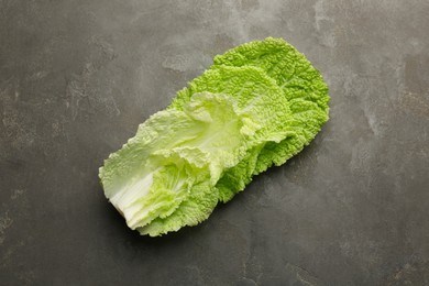 Photo of Fresh Chinese cabbage leaves on gray textured table, top view