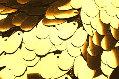 Image of Beautiful golden sequin fabric as background, closeup