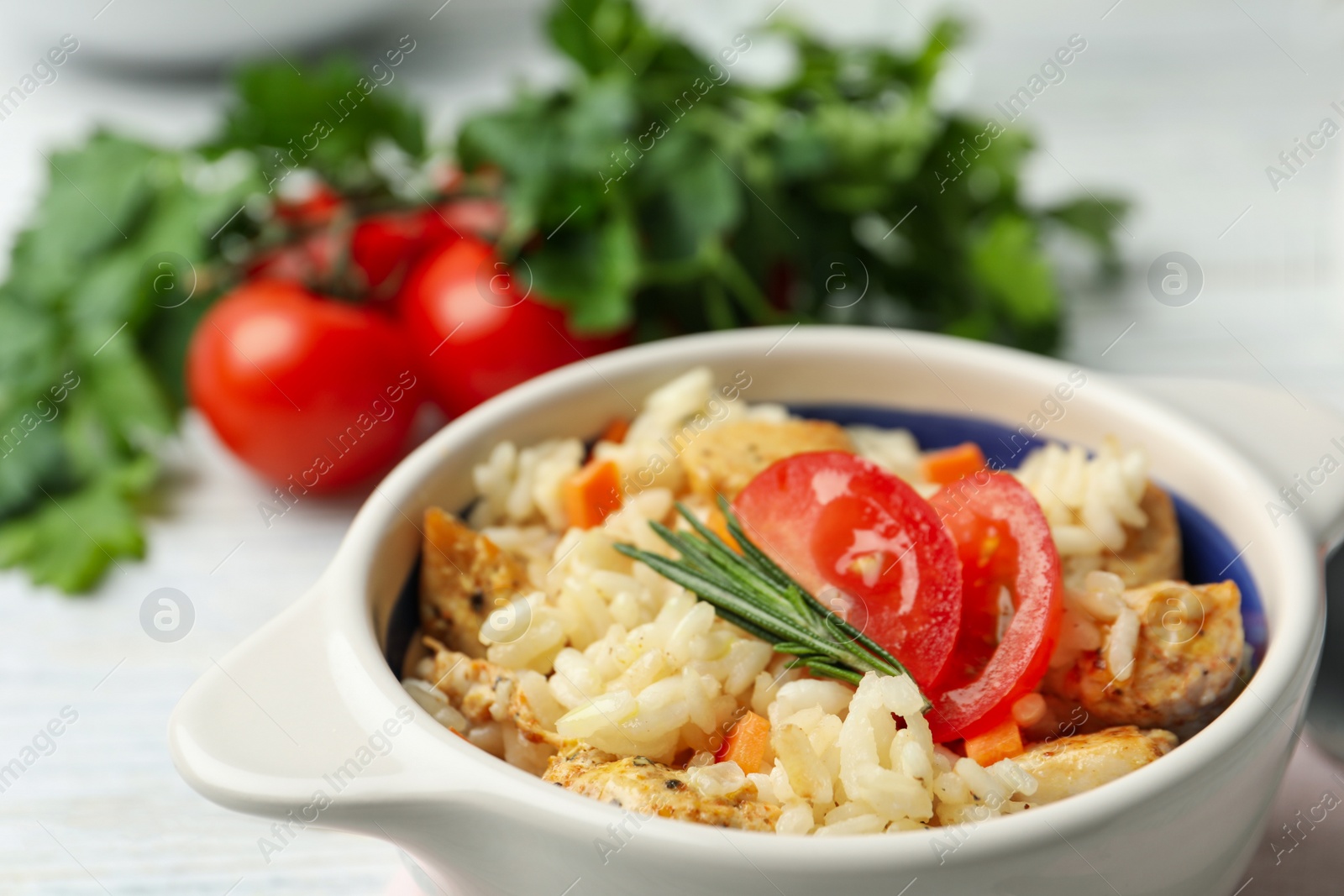 Photo of Delicious chicken risotto served in bowl, closeup