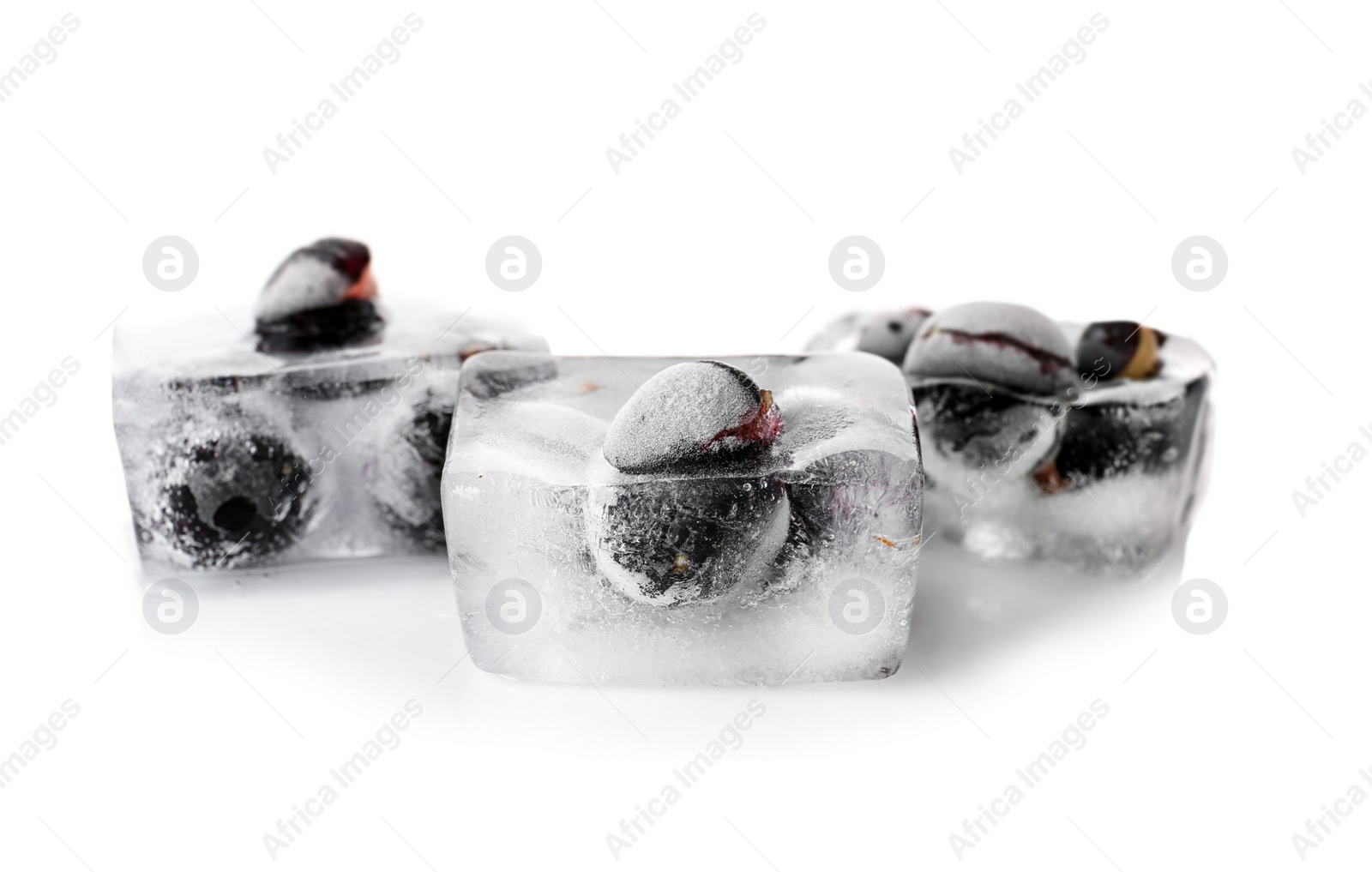 Photo of Fresh berries frozen in ice cubes on white background