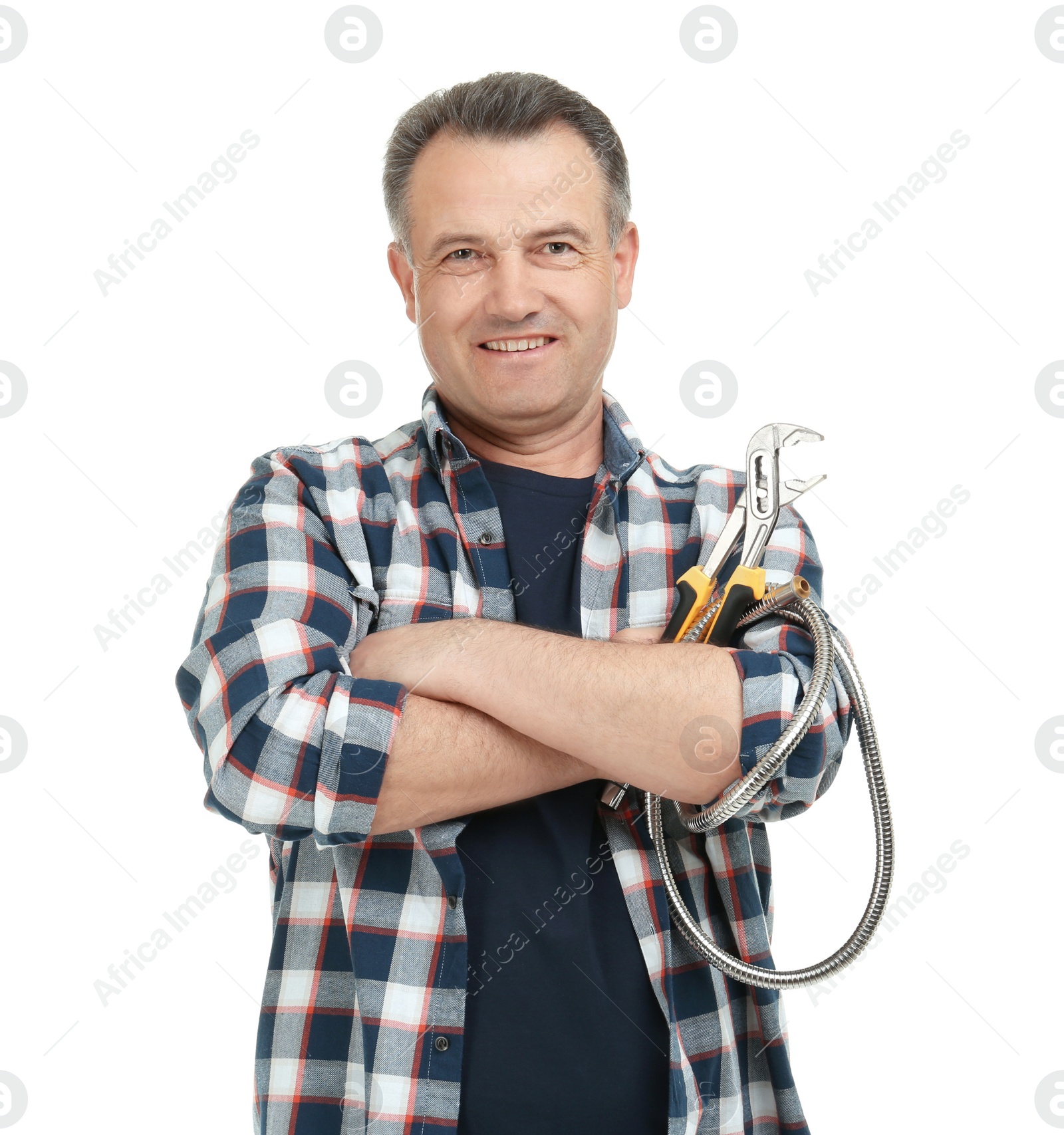 Photo of Mature plumber with hose and adjustable wrench on white background