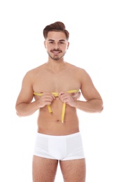 Photo of Fit man measuring his chest on white background. Weight loss
