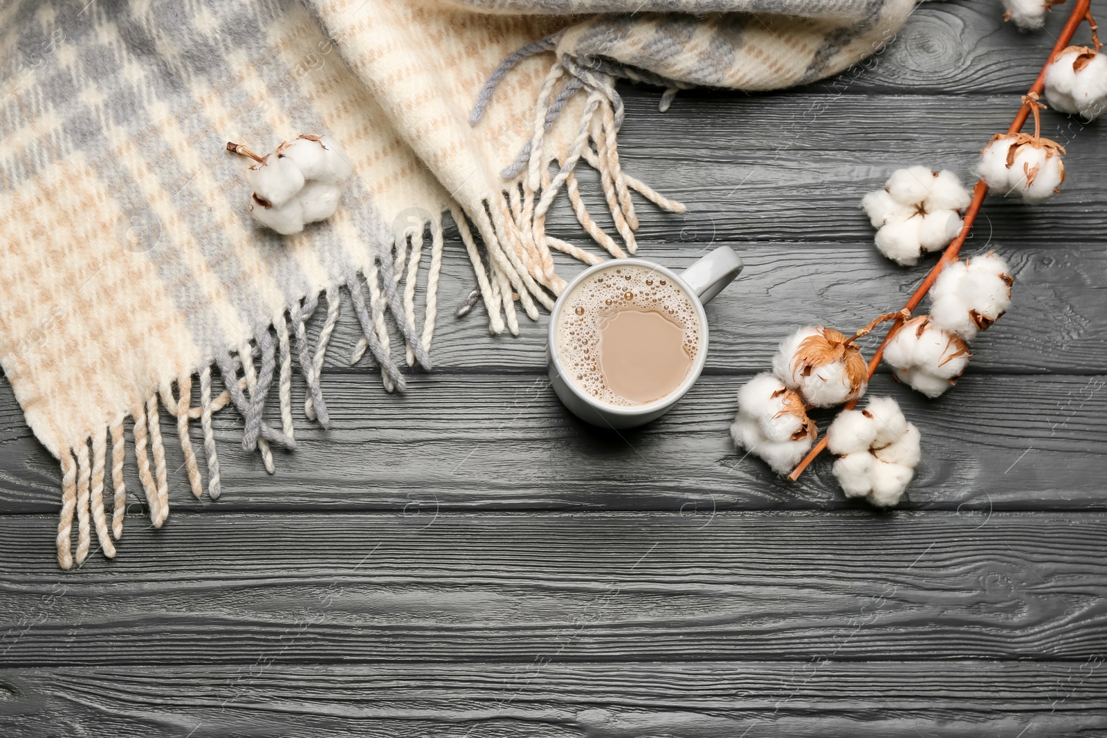 Photo of Flat lay composition with coffee and warm plaid on black wooden table, space for text