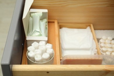 Photo of Storage of different feminine hygiene products in drawer, closeup