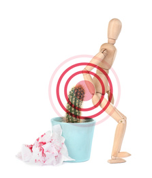 Hemorrhoid concept. Wooden human figure, cactus and sheets of toilet paper with blood on white background