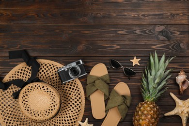 Photo of Flat lay composition with beach objects on wooden background, space for text