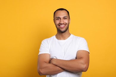 Photo of Portrait of happy African American man on orange background