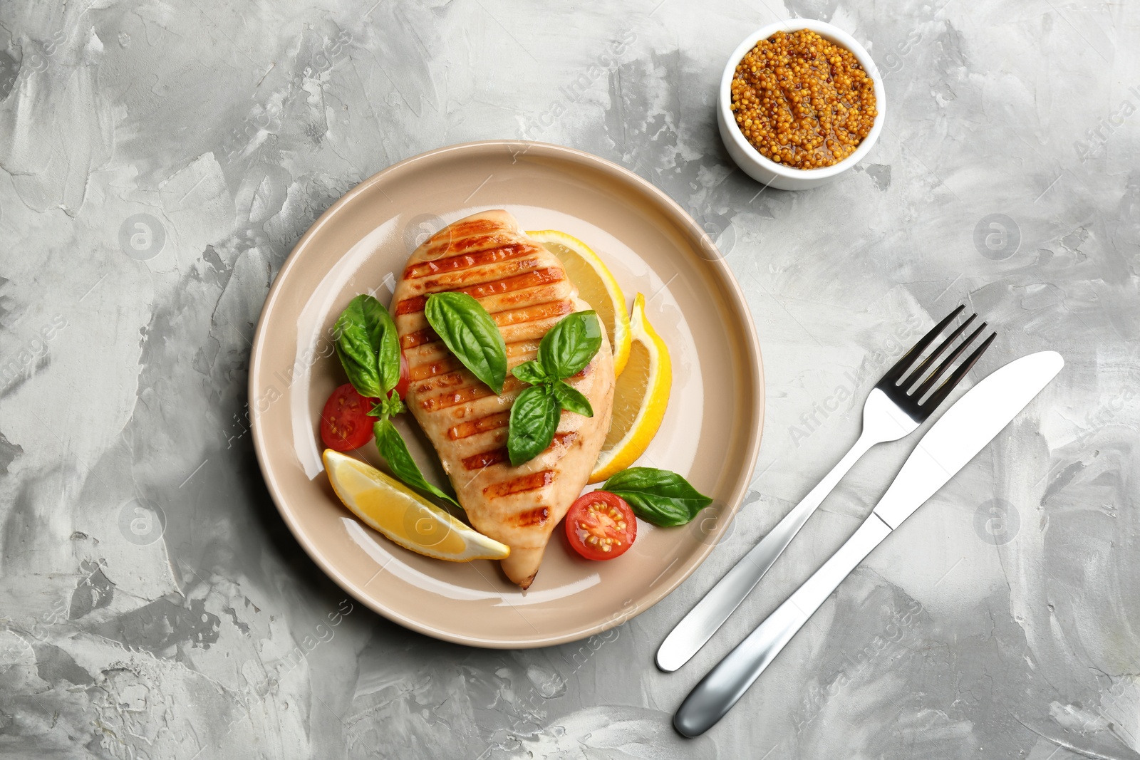 Photo of Tasty grilled chicken fillet served on light grey table, flat lay