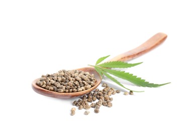 Photo of Wooden spoon with hemp seeds and leaf on white background