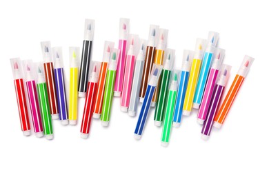 Photo of Many bright markers isolated on white, top view