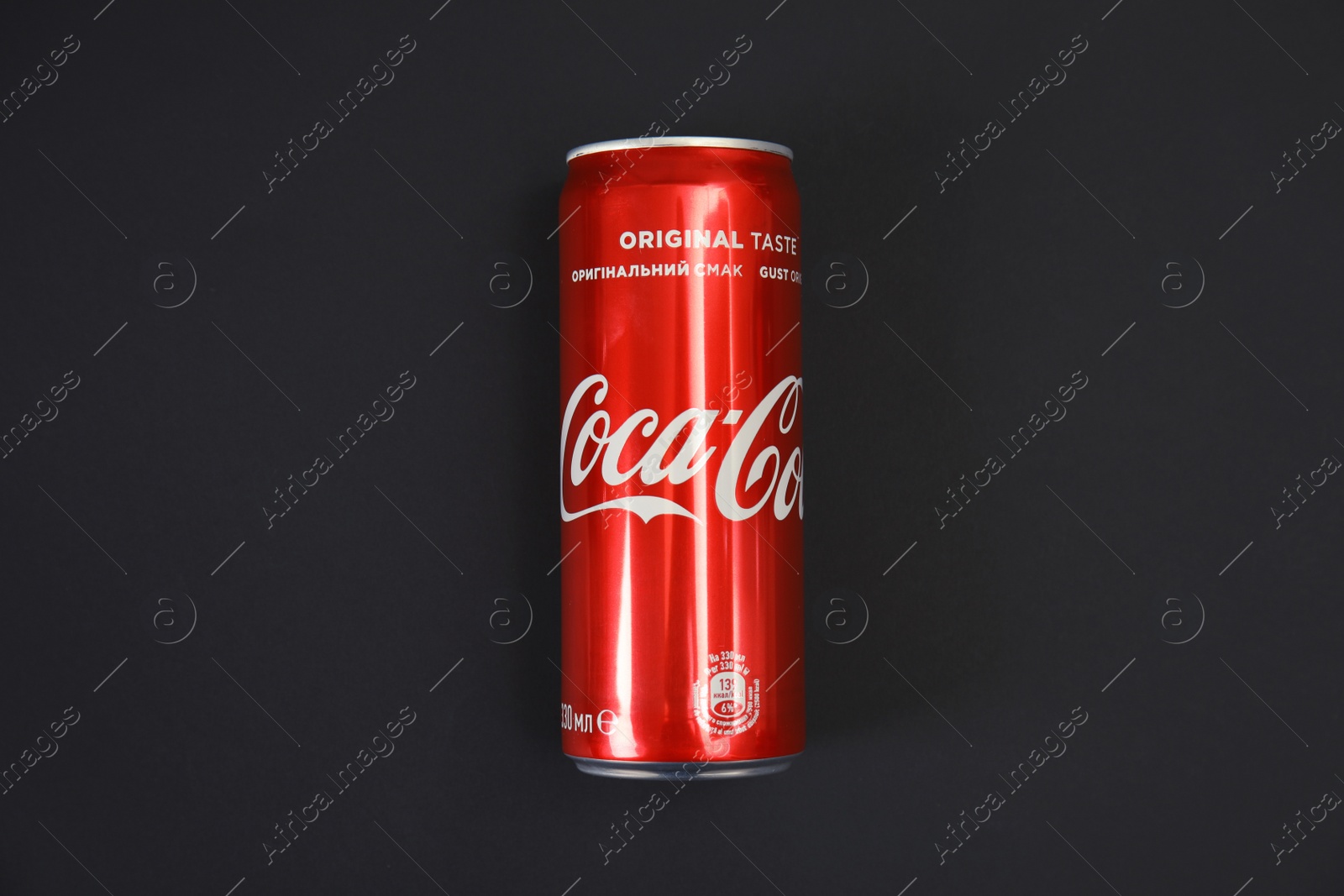 Photo of MYKOLAIV, UKRAINE - NOVEMBER 14, 2018: Coca-Cola can on black background, top view