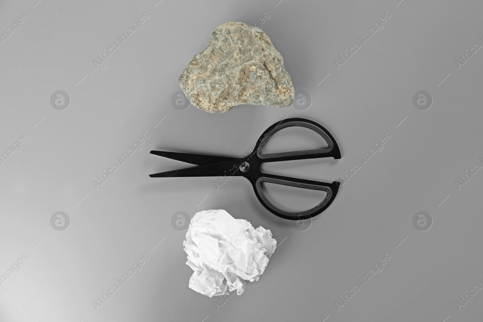 Photo of Flat lay composition with rock, paper and scissors on grey background