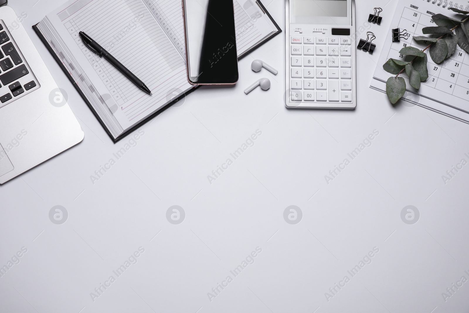 Photo of Laptop, smartphone and stationery on white background, flat lay. Space for text