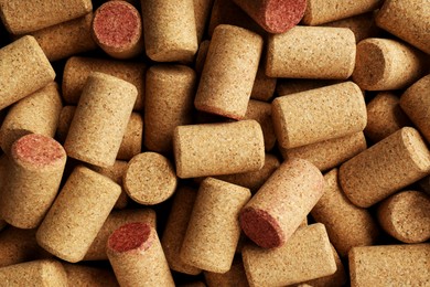 Photo of Many corks of wine bottles as background, top view