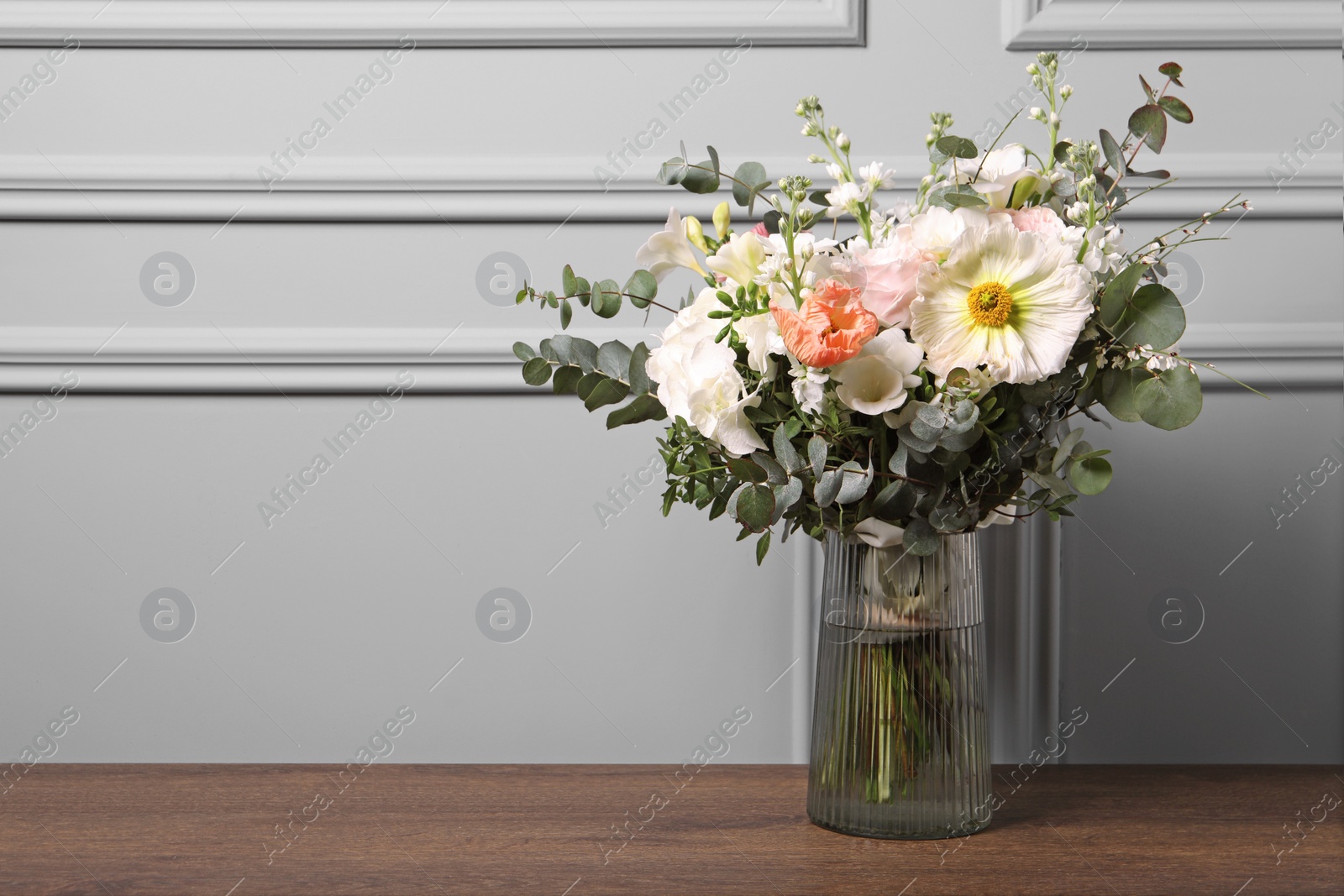 Photo of Bouquet of beautiful flowers on wooden table. Space for text