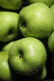 Fresh green apples with water drops as background, closeup