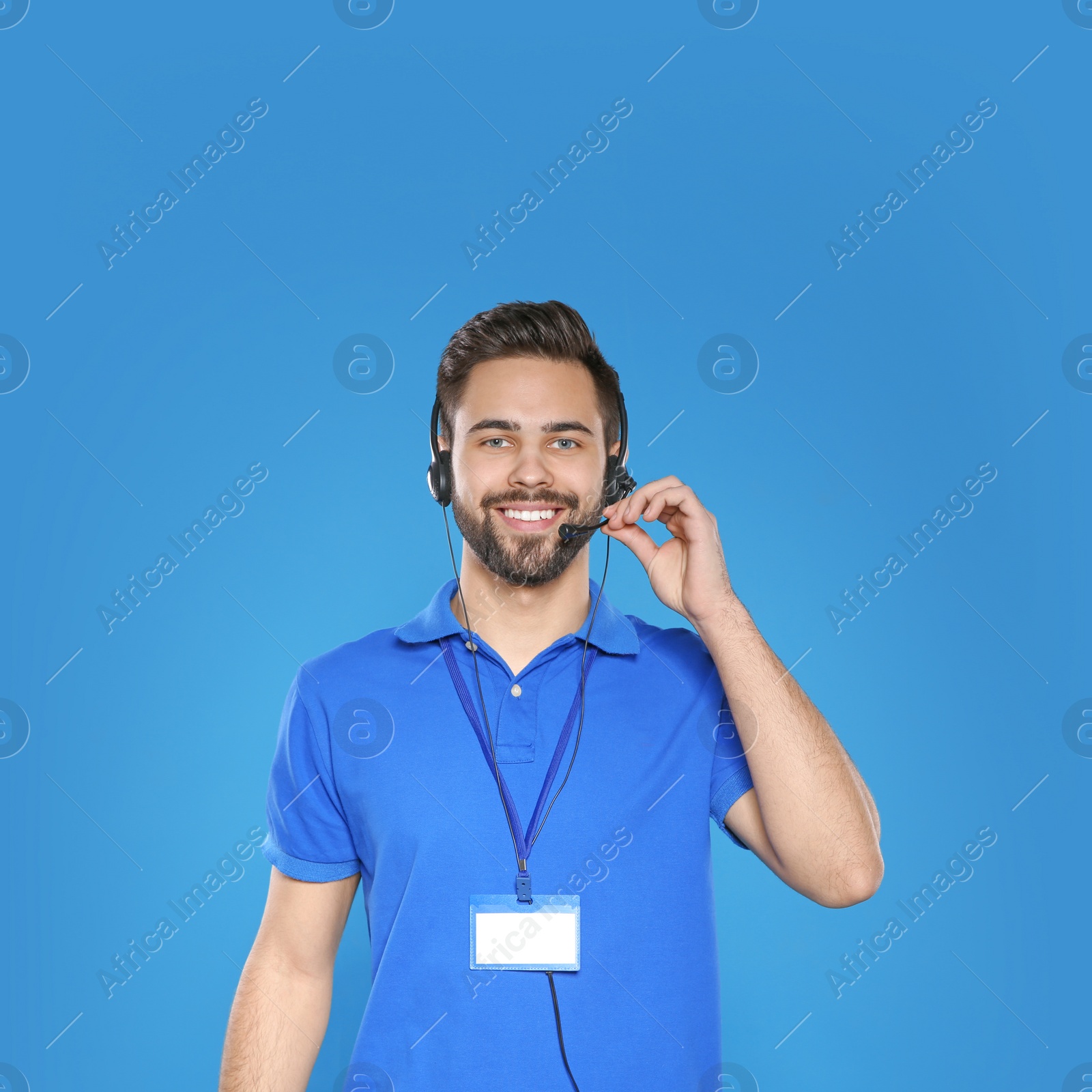 Photo of Portrait of technical support operator with headset on color background